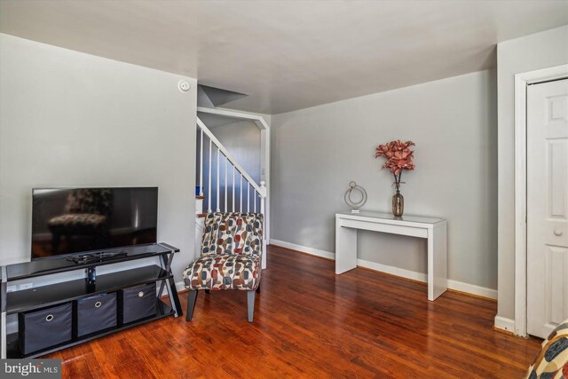 sitting room with baseboards and wood finished floors