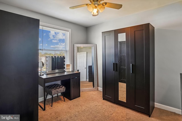 office area with light carpet, baseboards, and a ceiling fan