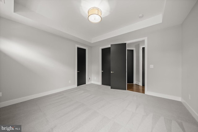 4012 N Upland St, Arlington, VA 22207 - unfurnished bedroom with a tray ceiling, carpet, and baseboards