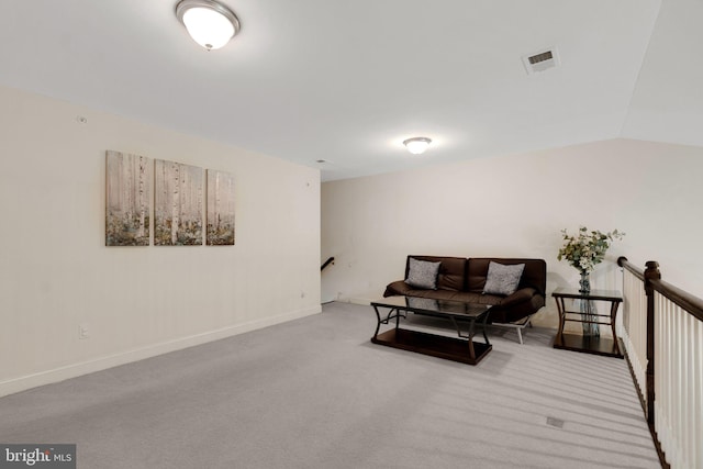 living area featuring an upstairs landing, carpet flooring, baseboards, and vaulted ceiling