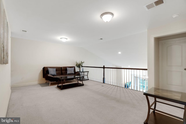sitting room with carpet floors, baseboards, and lofted ceiling