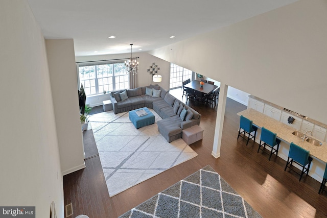 living area with a chandelier, wood finished floors, and recessed lighting
