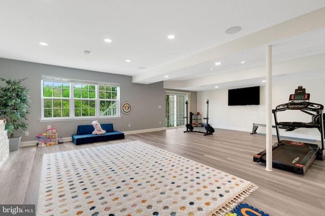 workout room with wood finished floors, baseboards, and recessed lighting