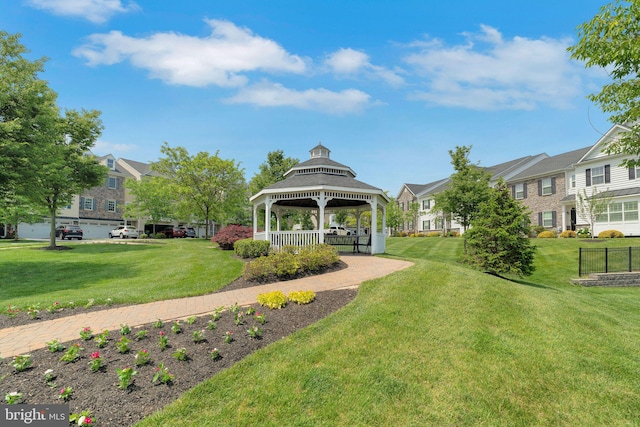 view of property's community with a gazebo, a residential view, and a yard