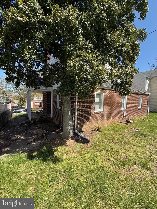 1127 45th Pl SE, Washington, DC 20019 - exterior space with a yard, brick siding, and fence