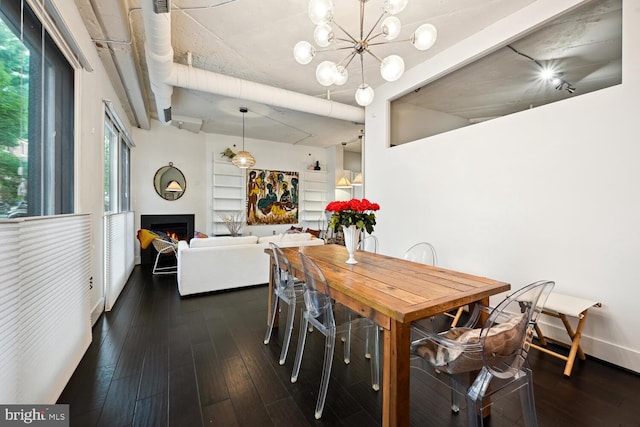 1700 Kalorama Rd NW Unit 207, Washington, DC 20009 - dining room featuring dark wood-type flooring, a warm lit fireplace, and a chandelier