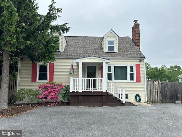 4611 Powder Mill Rd, Beltsville, MD 20705 - new england style home featuring roof with shingles, fence, and a chimney