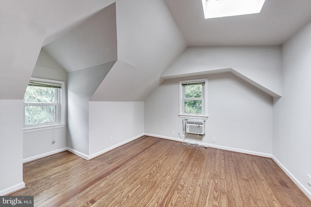 4611 Powder Mill Rd, Beltsville, MD 20705 - additional living space with a wealth of natural light, baseboards, vaulted ceiling with skylight, and wood finished floors