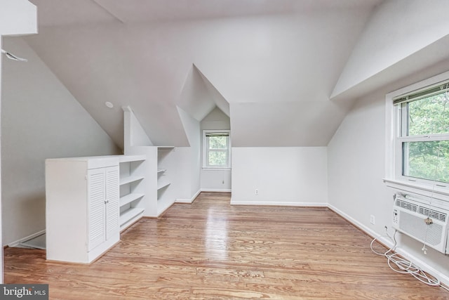 4611 Powder Mill Rd, Beltsville, MD 20705 - additional living space with lofted ceiling, a wall mounted AC, baseboards, and wood finished floors