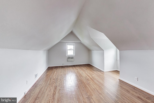 4611 Powder Mill Rd, Beltsville, MD 20705 - additional living space featuring wood finished floors, a wall mounted air conditioner, lofted ceiling, and baseboards