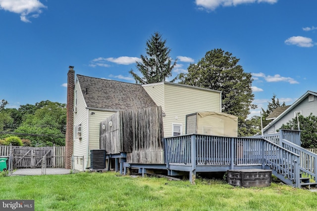 4611 Powder Mill Rd, Beltsville, MD 20705 - back of property featuring a chimney, fence, central air condition unit, a deck, and roof with shingles