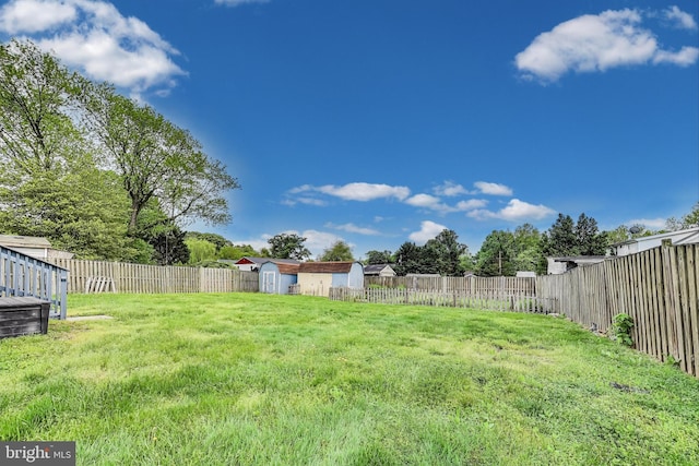 4611 Powder Mill Rd, Beltsville, MD 20705 - view of yard featuring an outbuilding, a fenced backyard, and a storage unit