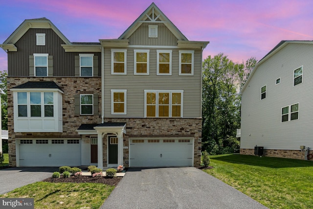 view of front facade with board and batten siding, driveway, an attached garage, stone siding, and a front lawn