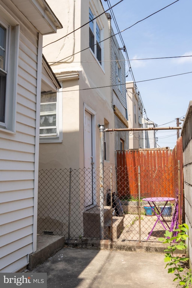 view of home's exterior featuring stucco siding and fence