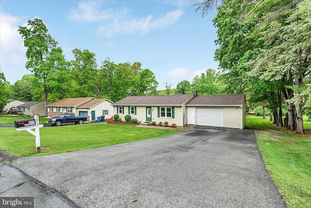 single story home with an attached garage, driveway, and a front yard