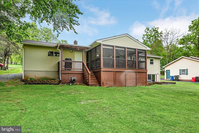 rear view of property featuring a sunroom, a yard, stairs, and a chimney