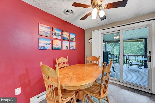 dining area featuring a textured ceiling and a ceiling fan