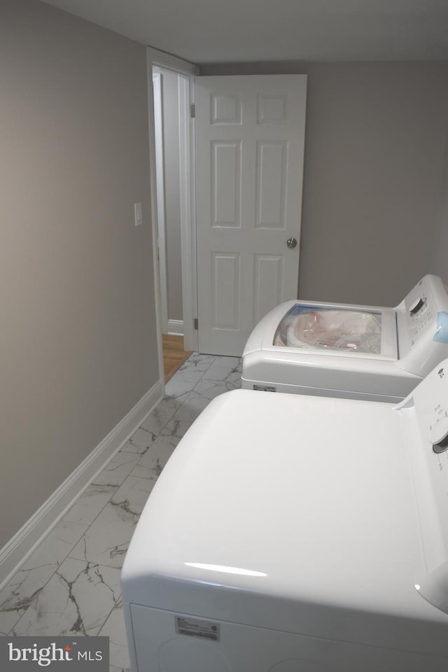 2008 Coast Guard Dr, Stafford, VA 22554 - laundry room featuring light marble finish flooring, washer and clothes dryer, and baseboards