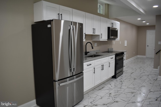 2008 Coast Guard Dr, Stafford, VA 22554 - kitchen featuring stainless steel appliances, a sink, recessed lighting, light stone countertops, and white cabinets
