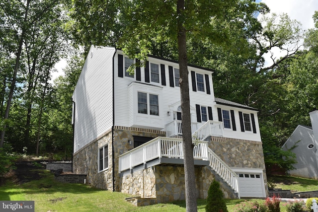 2008 Coast Guard Dr, Stafford, VA 22554 - rear view of property featuring stone siding, stairs, a garage, and a lawn