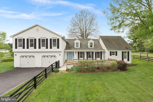 view of front facade featuring driveway, a porch, a garage, and roof with shingles