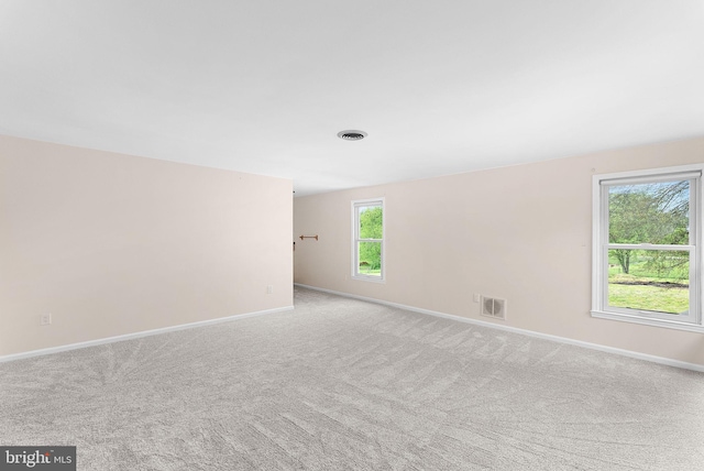 carpeted spare room with baseboards