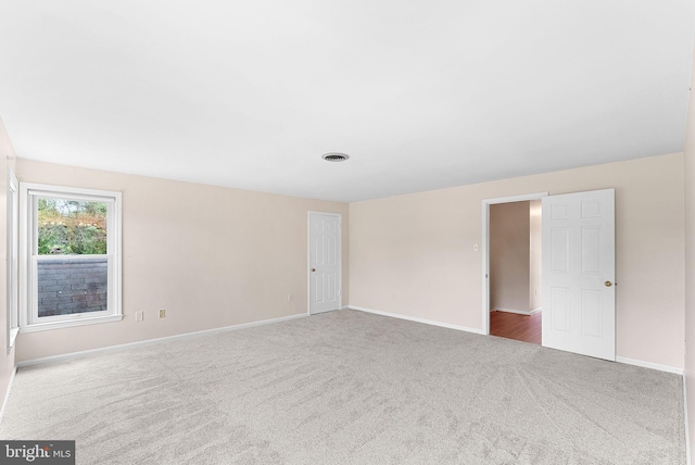 empty room with carpet floors and baseboards