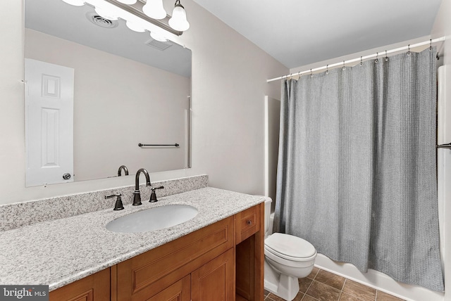 full bath featuring toilet, vanity, shower / tub combo, and tile patterned floors