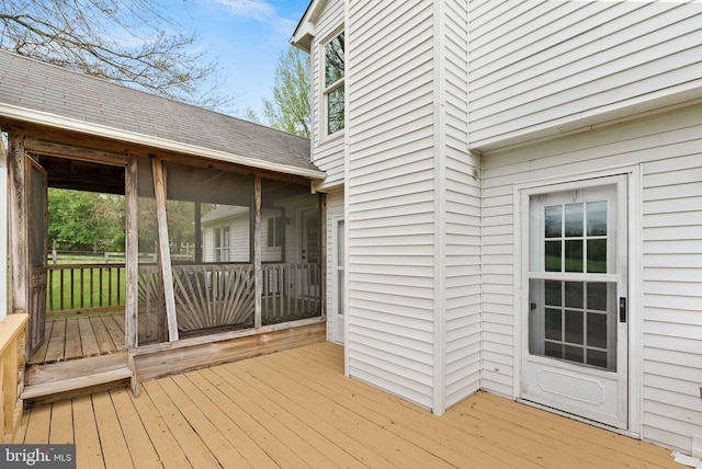wooden deck with a sunroom