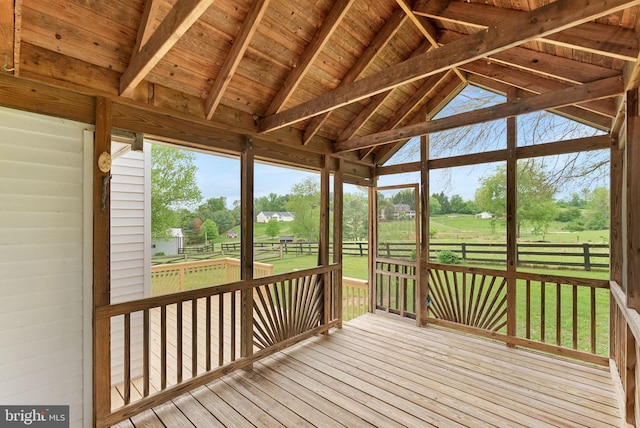 unfurnished sunroom with lofted ceiling