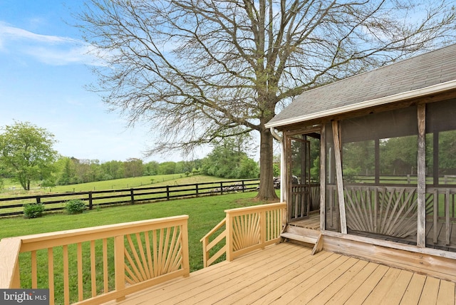 deck featuring a sunroom and a view of countryside