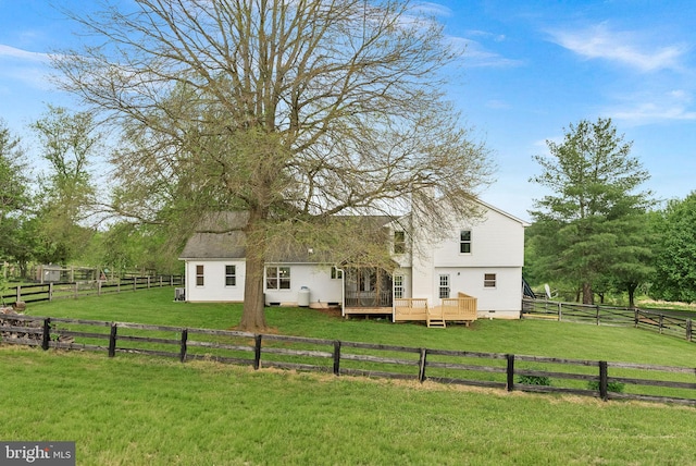 back of property with a deck, a view of countryside, and crawl space