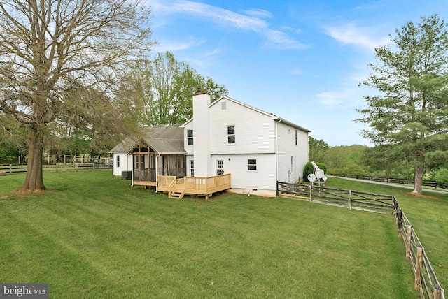 back of property featuring a deck and a chimney