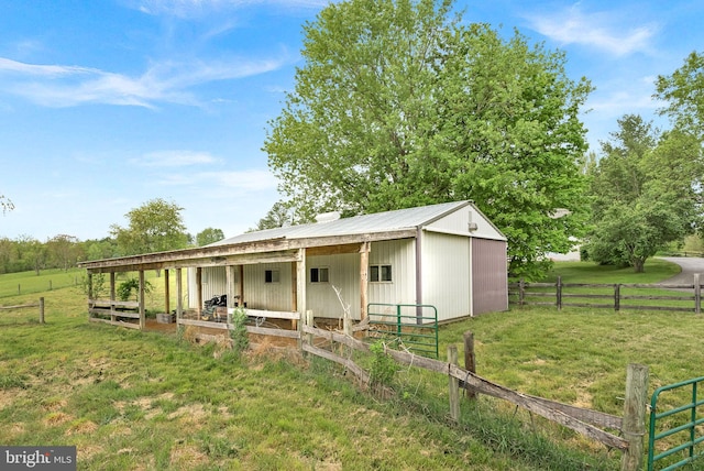 rear view of house featuring an exterior structure, an outbuilding, and metal roof