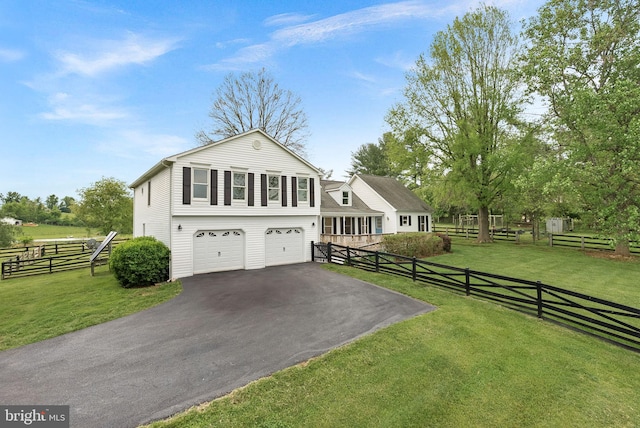 view of front facade with asphalt driveway and a garage