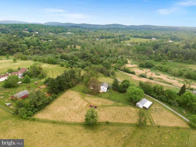 aerial view of property and surrounding area with a mountainous background and rural landscape