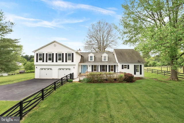 view of front facade featuring asphalt driveway, a porch, an attached garage, a chimney, and roof with shingles