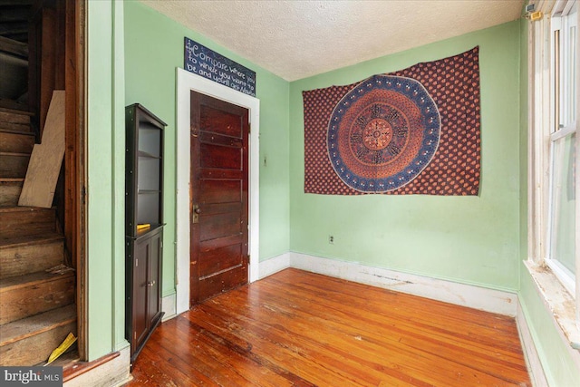 21 W Pall Mall St, Winchester, VA 22601 - entrance foyer featuring stairs, a textured ceiling, wood-type flooring, and baseboards
