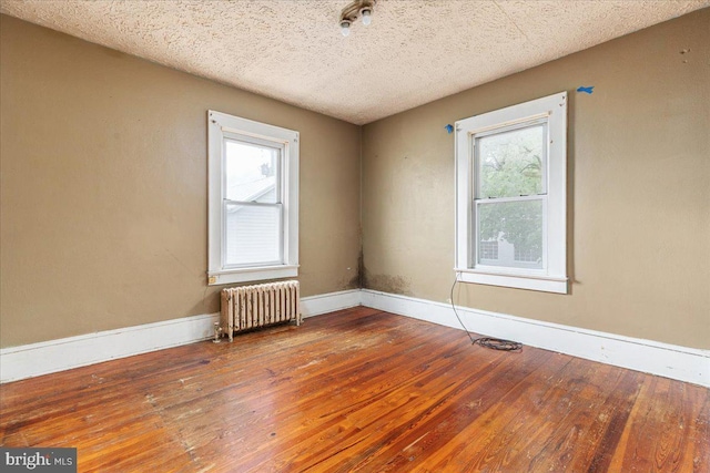 21 W Pall Mall St, Winchester, VA 22601 - unfurnished room with radiator heating unit, hardwood / wood-style flooring, plenty of natural light, baseboards, and a textured ceiling