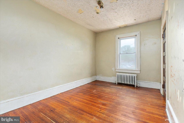 21 W Pall Mall St, Winchester, VA 22601 - empty room featuring radiator, hardwood / wood-style floors, baseboards, and a textured ceiling