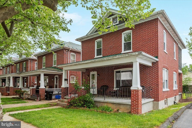 21 W Pall Mall St, Winchester, VA 22601 - american foursquare style home featuring covered porch, brick siding, and a front yard