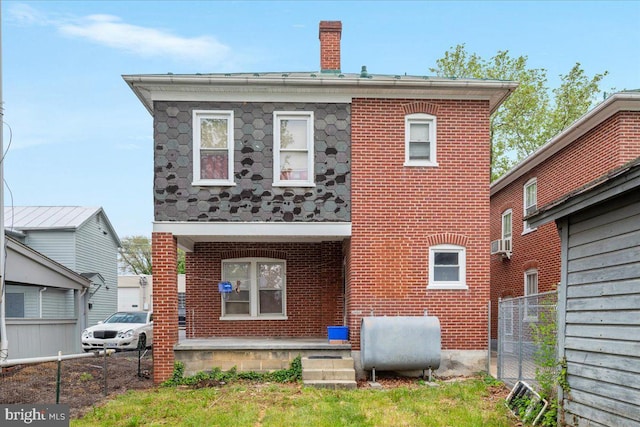 21 W Pall Mall St, Winchester, VA 22601 - rear view of house with heating fuel, brick siding, a chimney, and cooling unit