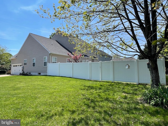 exterior space with fence and a garage
