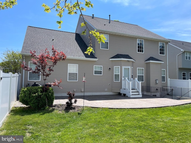 rear view of property featuring a yard, a patio area, and fence
