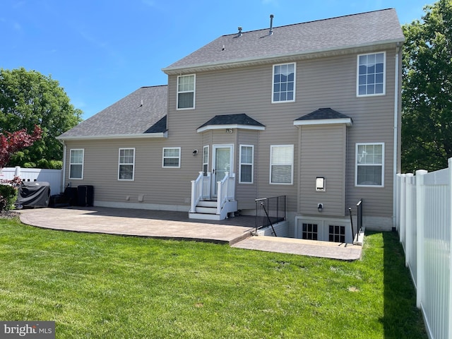 back of house featuring a lawn, a patio, and fence