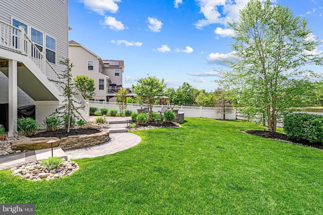 view of yard featuring stairway and fence