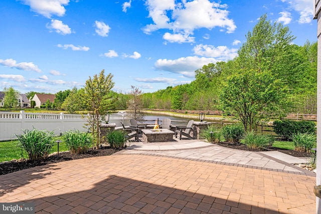 view of patio featuring a fire pit and fence