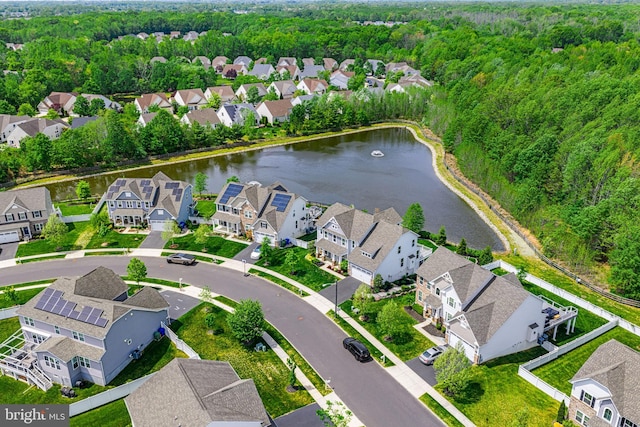 bird's eye view featuring a water view, a view of trees, and a residential view