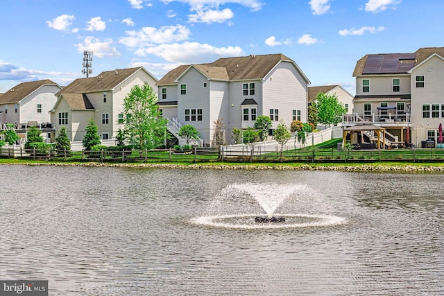 water view with fence and a residential view