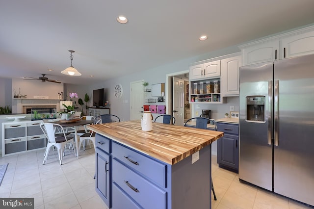 2969 Hearthside Ln, Lancaster, PA 17601 - kitchen with stainless steel refrigerator with ice dispenser, wood counters, white cabinets, blue cabinetry, and recessed lighting